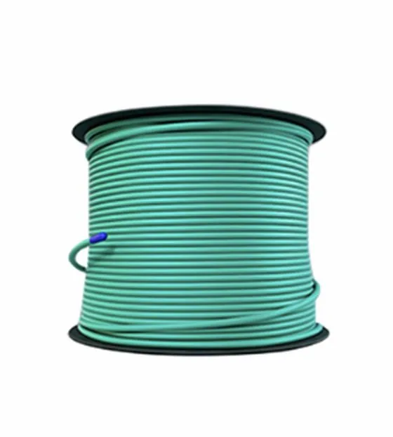 A reel of green detonating cord, wound on its spool, on a white background.